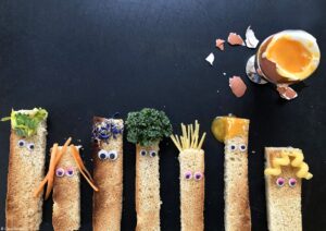 A photo of dressed up soldiers and a cracked open soft-boiled egg - photography competition submission
