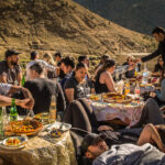 A photo of a large group of people enjoying a feast in a Berber village - photography competition submission