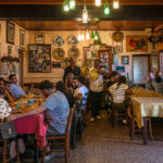 A photo of a family enjoying food in a small restaurant, celebrating a 60th birthday - photography competition submission