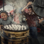 A photo of meat dumplings being steam-cooked in the streets - photography competition submission